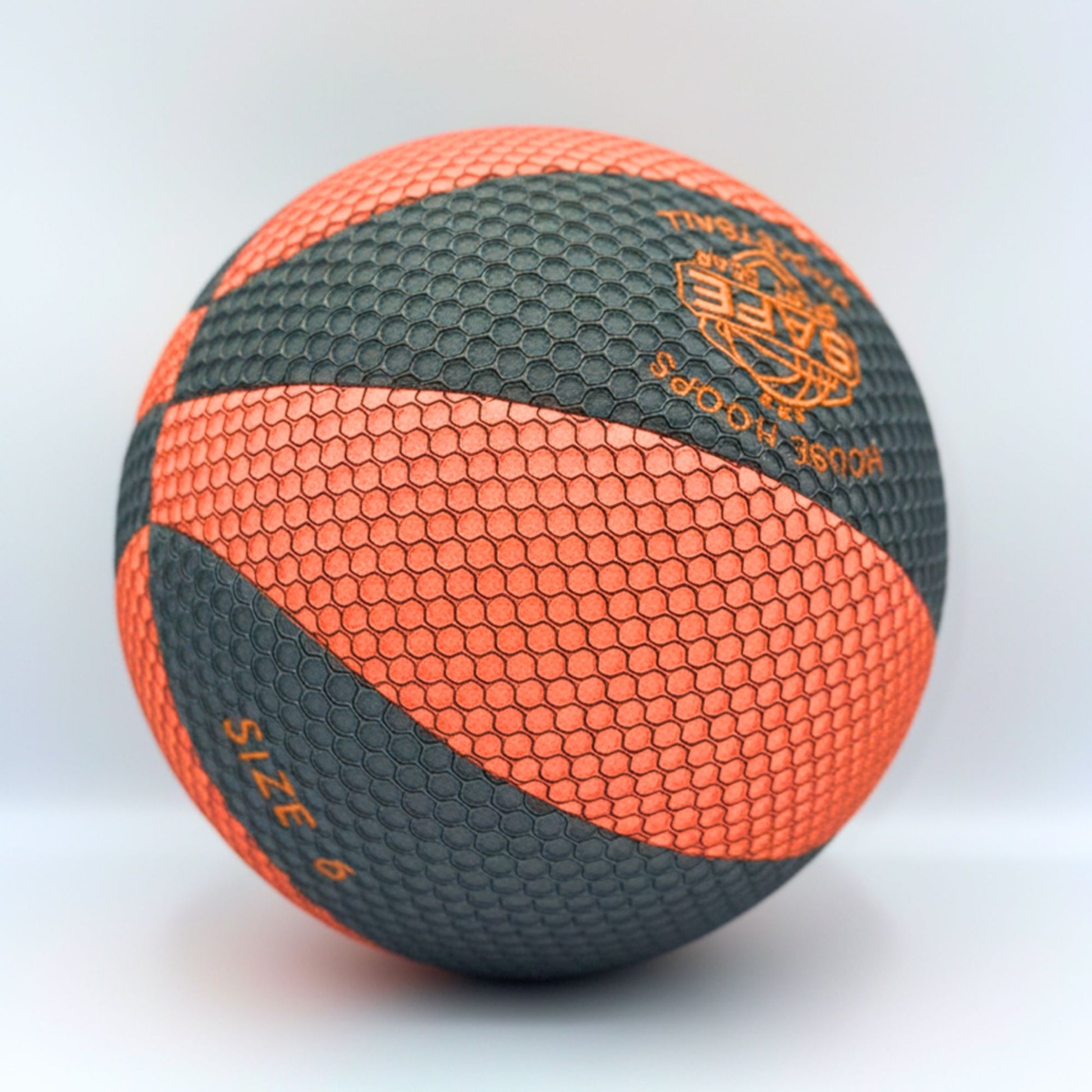 Orange and black basketball with brand logo on a white background