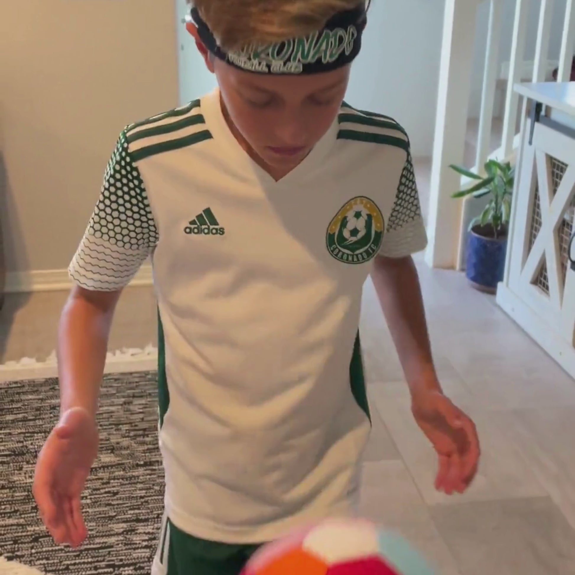 Young boy playing with The House Ball - soccer ball made for home, inside his home.