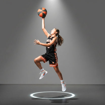 Basketball player in action with a spotlight on a gray background