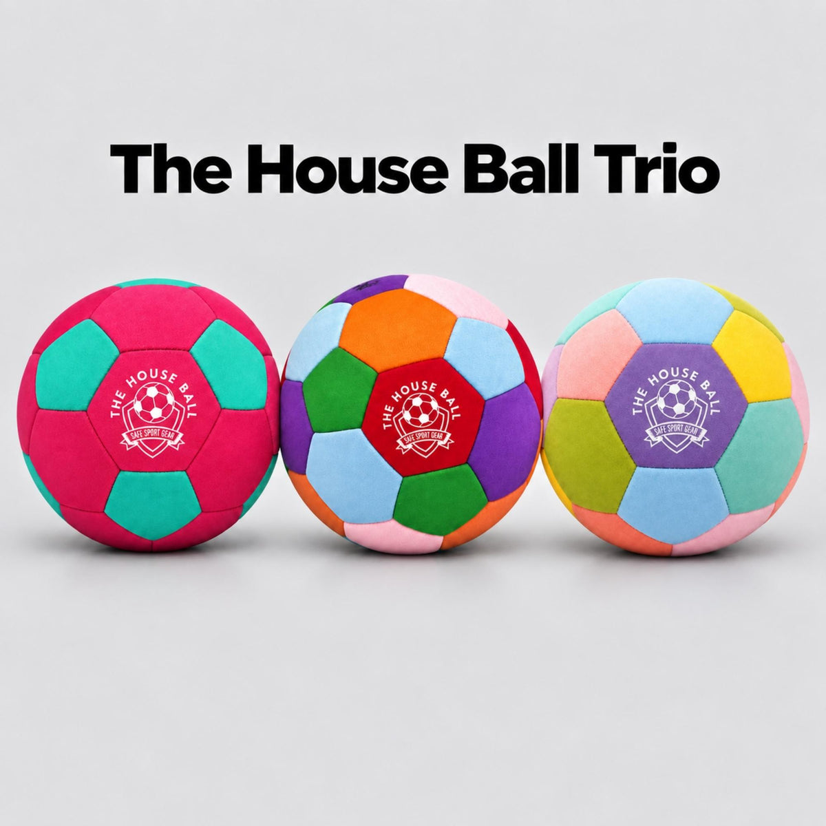 Three colorful House Balls displayed side by side on a light gray background with the text 'The House Ball Trio' above them. The balls feature multiple bright colors in a geometric pattern, with a purple, pink, green, and orange center panel printed with the 'Safe Sport Gear' logo.