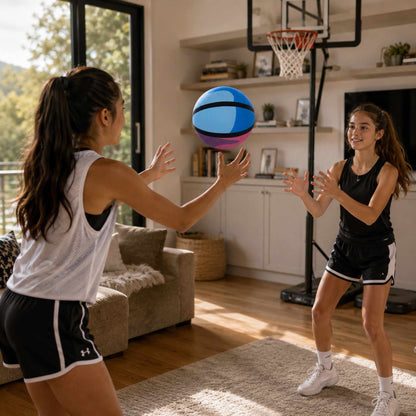 Two young women playing HouseHoops basketball - SH  in a living room.